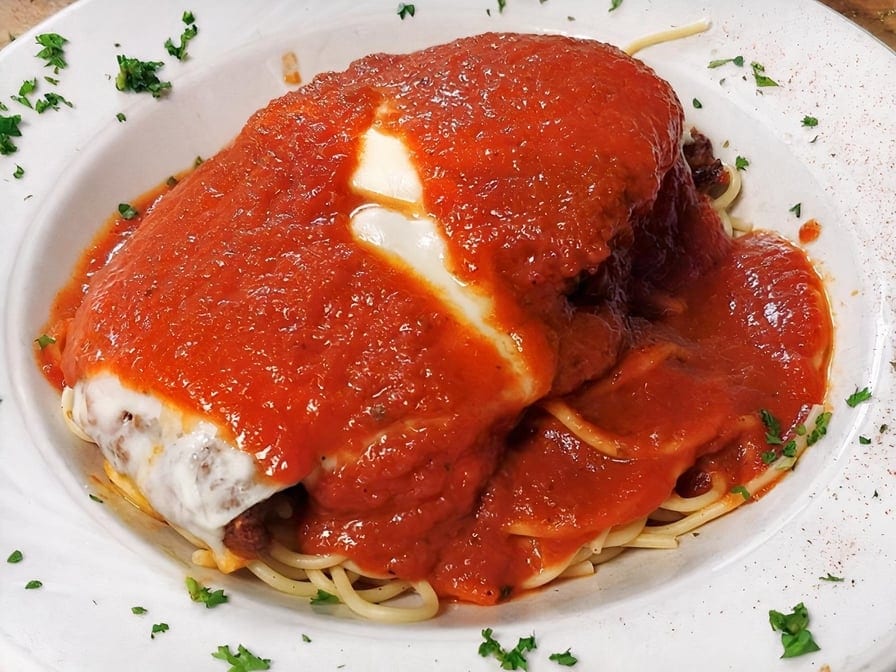 Veal parmesan over pasta.